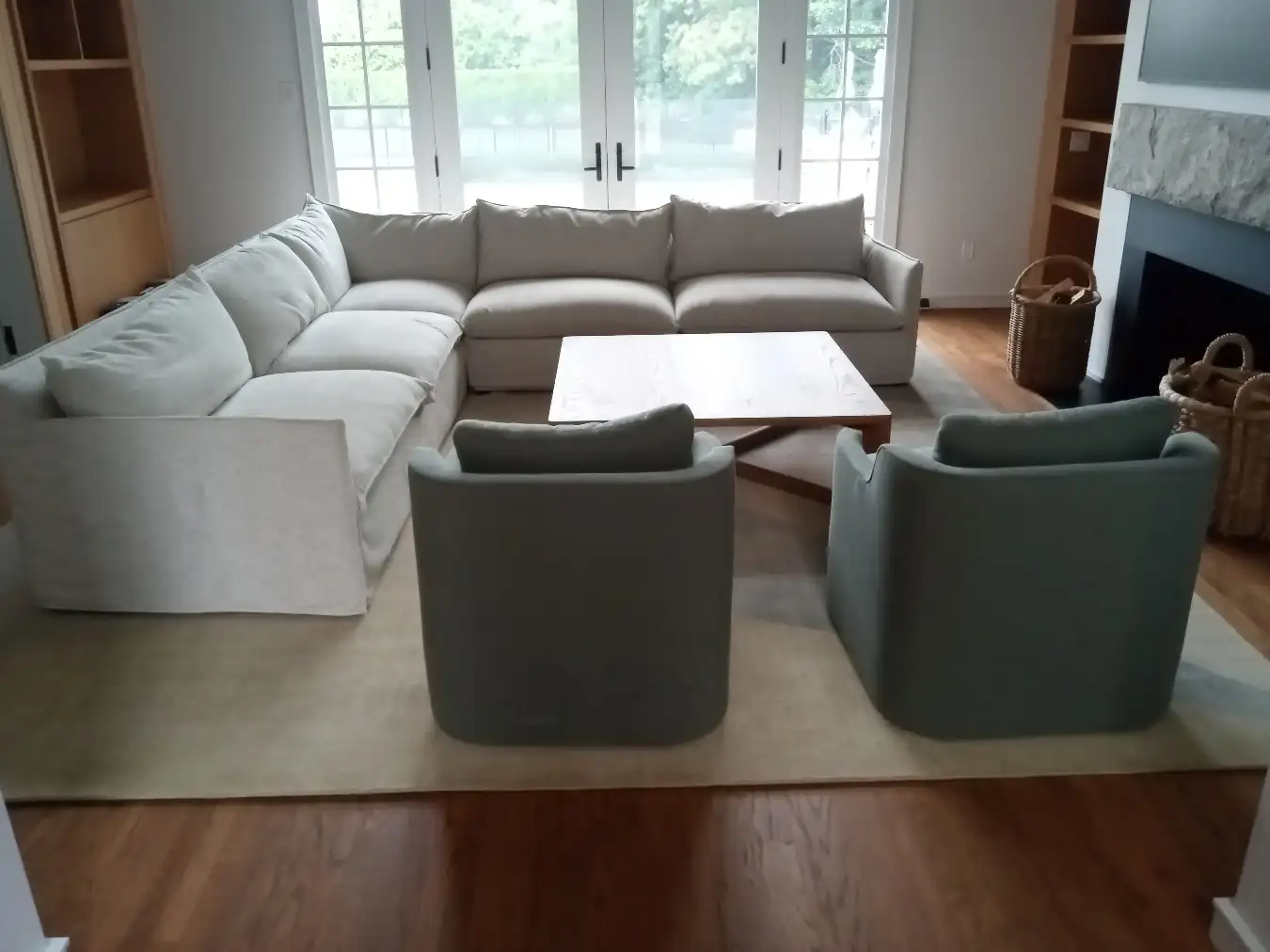 Sectional sofa with two chairs and coffee table arranged in a customer’s living room by RF Delivery in Long Island, NY