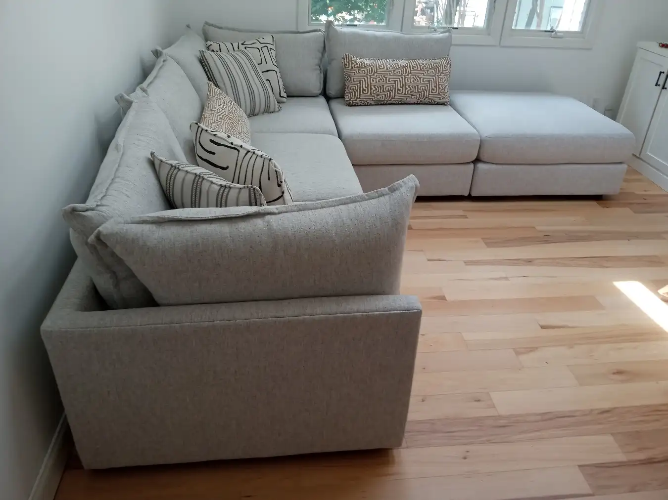 Sectional sofa positioned in the corner of a customer’s living room by RF Delivery