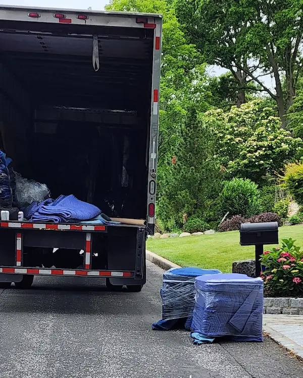 Residential furniture delivery by RF Delivery in Long Island NY with truck and wrapped items